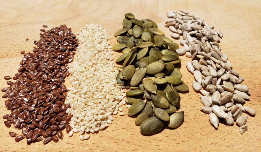 Seed cycling in your fertility smoothie- how to alternate seeds during your menstrual, follicular, ovulatory, and luteal phases to boost fertility when trying to conceive.